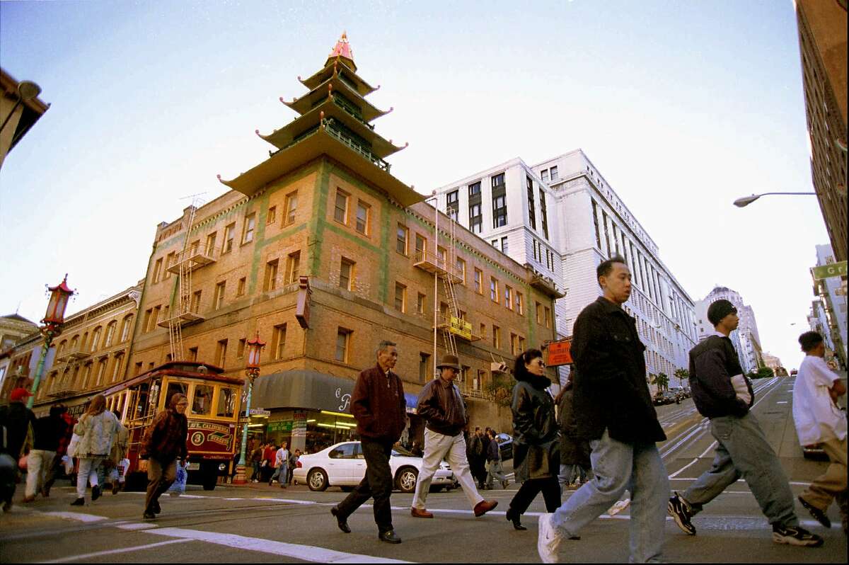 FILE--The Sing Fat Co. building, topped by an ornamental corner pagoda dominates this intersection at California and Grant Streets in San Francisco's Chinatown in this Dec. 1997 file photo. The building with its distinct pseudo-Chinese shape was designed to draw tourists. The building was was one of the first constructed in Chinatown after the 1906 earthquake and helped create a new shopping mecca. (AP Photo/Julie Stupsker,File)