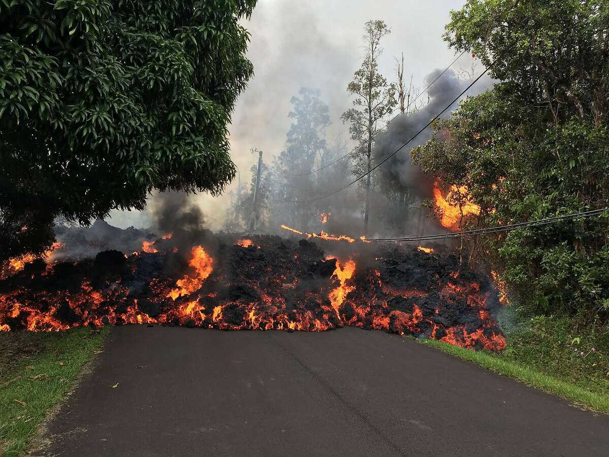 TOPSHOT - This image obtained May 9, 2018, released by the US Geological Survey shows a lava flow moving on Makamae Street in Leilani Estates at 09:32 am local time, on May 6, 2018 in Leilani Estates, Hawaii. The Kilauea Volcano, the most active in Hawaii, was highly unstable on May 6, 2018, as lava spouted into the air and fissures emitted deadly gases -- hazards that have forced thousands of people to evacuate. / AFP PHOTO / US Geological Survey / HO / RESTRICTED TO EDITORIAL USE - MANDATORY CREDIT "AFP PHOTO / US Geological Survey/HO" - NO MARKETING NO ADVERTISING CAMPAIGNS - DISTRIBUTED AS A SERVICE TO CLIENTS HO/AFP/Getty Images