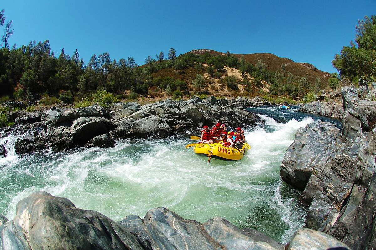 Experienced O.A.R.S. guides steer rafts through rapids on the American River.