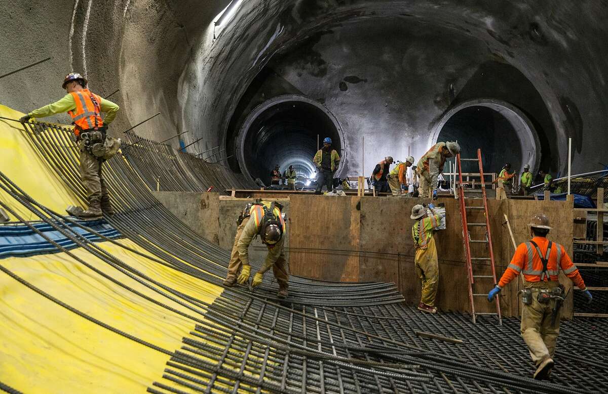 Workers continue construction on the two main tunnels and platform location for the future Central Subway near Stockton and Washington streets Tuesday, April 3, 2018 in San Francisco, Calif.