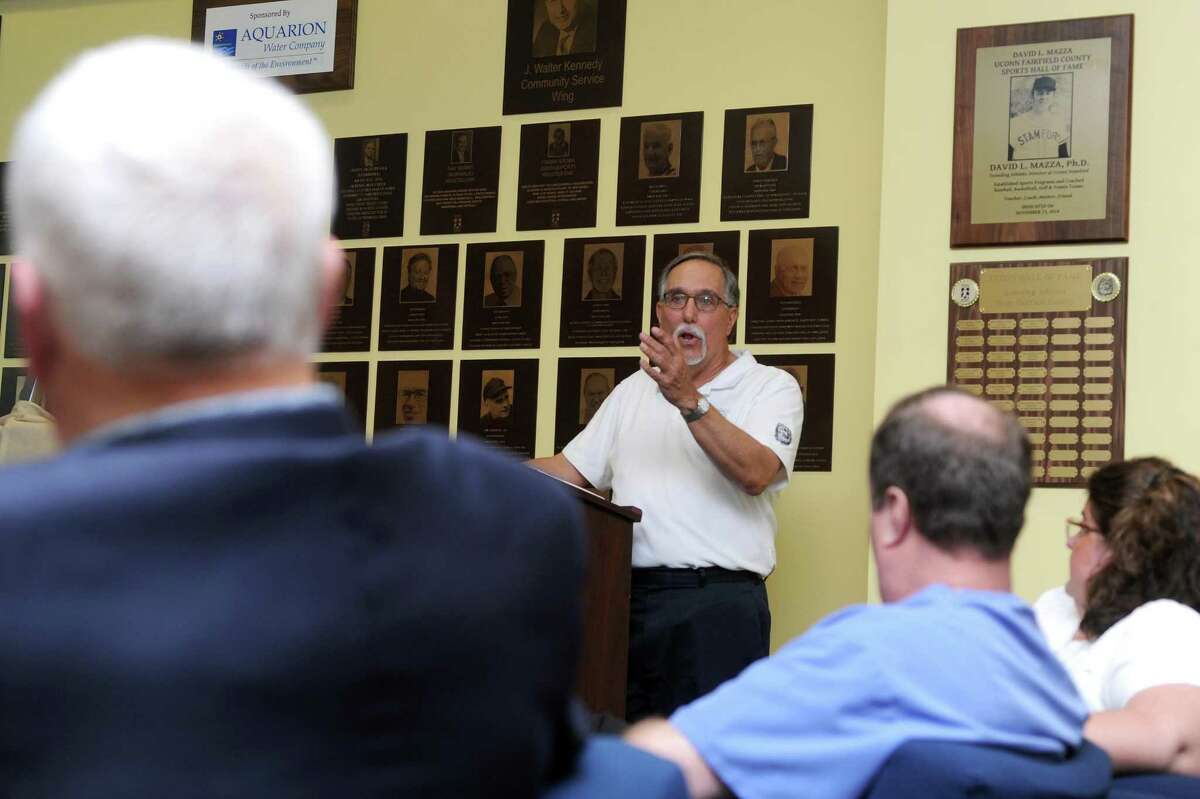 Fairfield County Sports Commission executive director Tom Chiappetta speaks about the honored athletes during the plaque unveiling ceremony for the 2017 inductees into the Fairfield County Hall of Fame inside UConn Stamford in downtown Stamford, Conn. on Thursday, May 10, 2018.