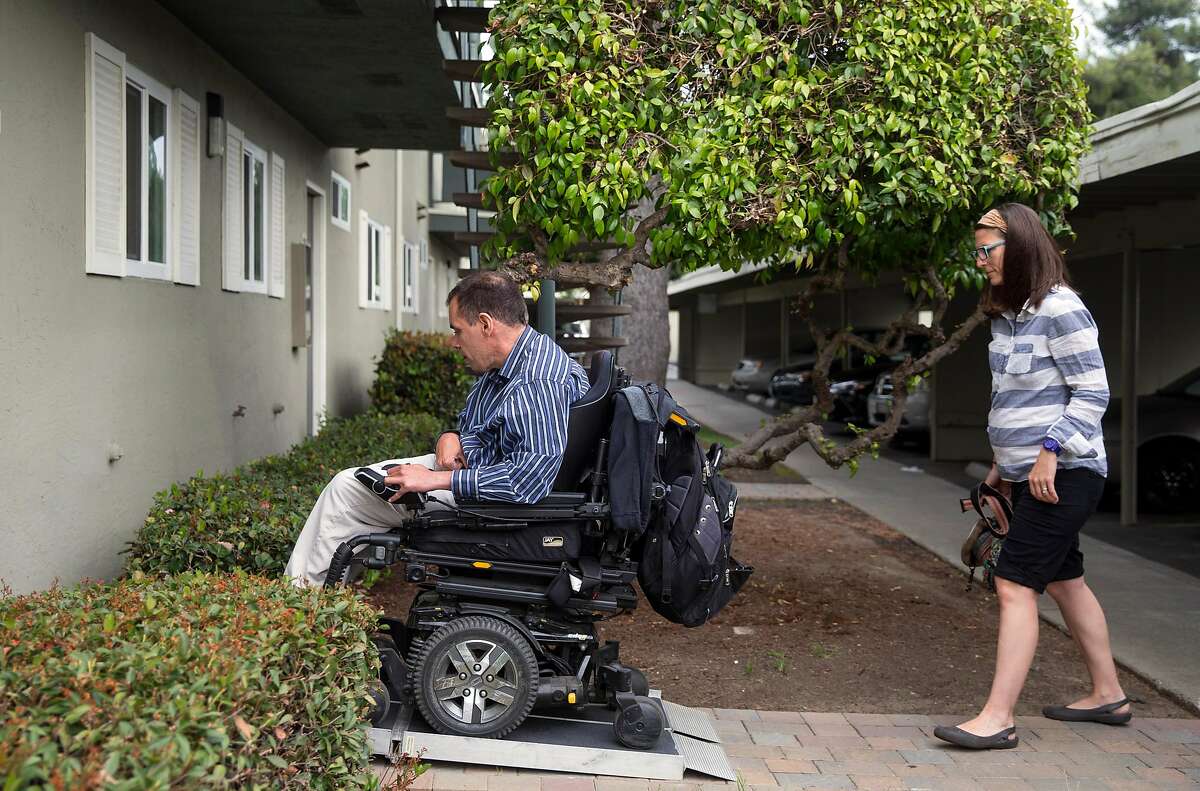 Jessica Quiambo, a behavioral analyst, follows her patient Ken Brown, 41, into his home before holding a session in Fremont, Calif. Saturday, May 5, 2018.