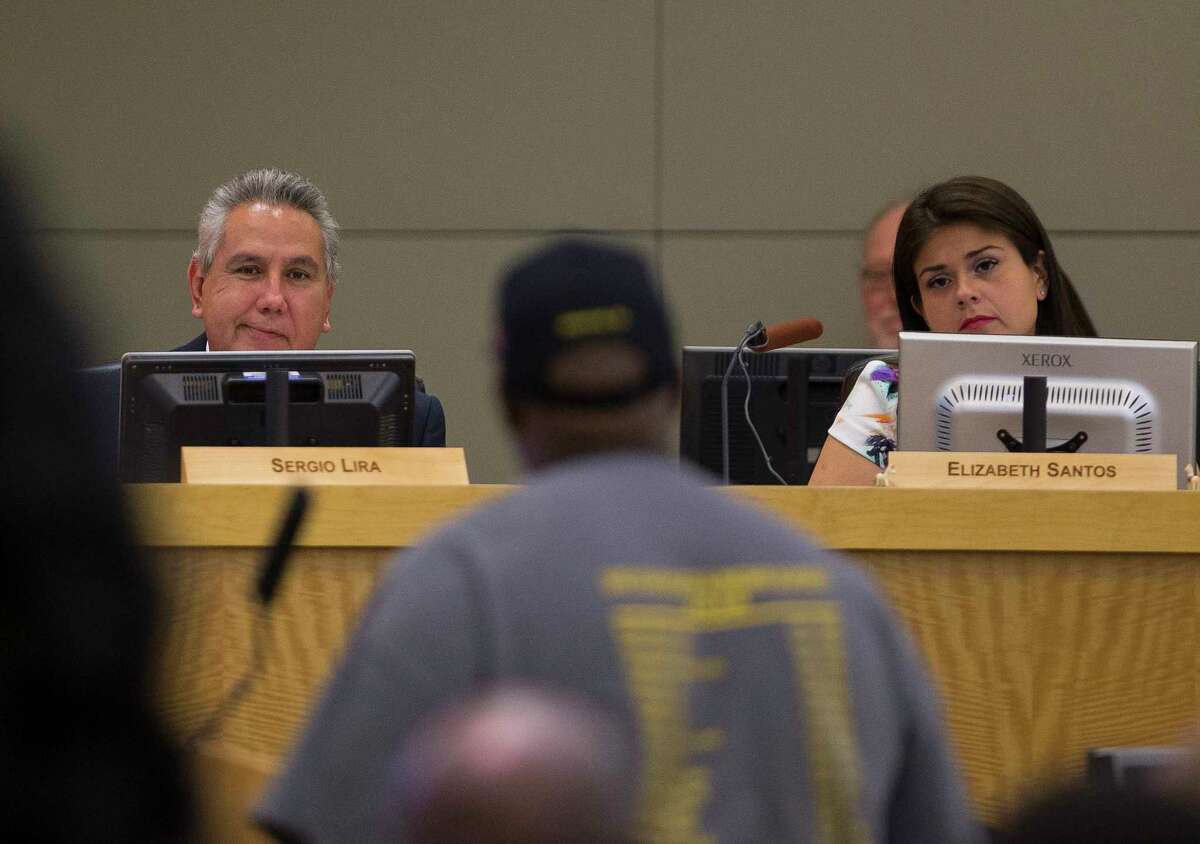 Board members Sergio Lira and Elizabeth Santos listen to Gerry Monroe make a public comment during a Houston Independent School District board meeting, Thursday, May 10, 2018, in Houston.