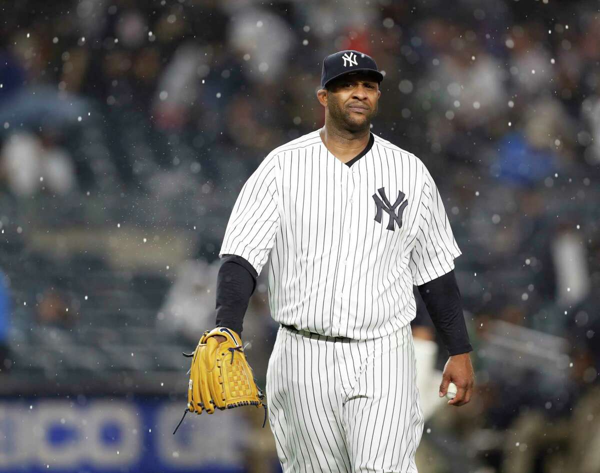 New York Yankees starting pitcher CC Sabathia walks off the field as a heavy rain falls during the fifth inning of the team's baseball game against the Boston Red Sox in New York, Thursday, May 10, 2018.