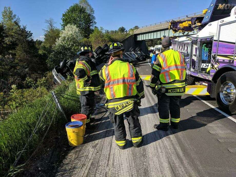 Crews with the Danbury Fire Department work on an overturned truck on Intestate 84 Friday. Photo: / Contributed