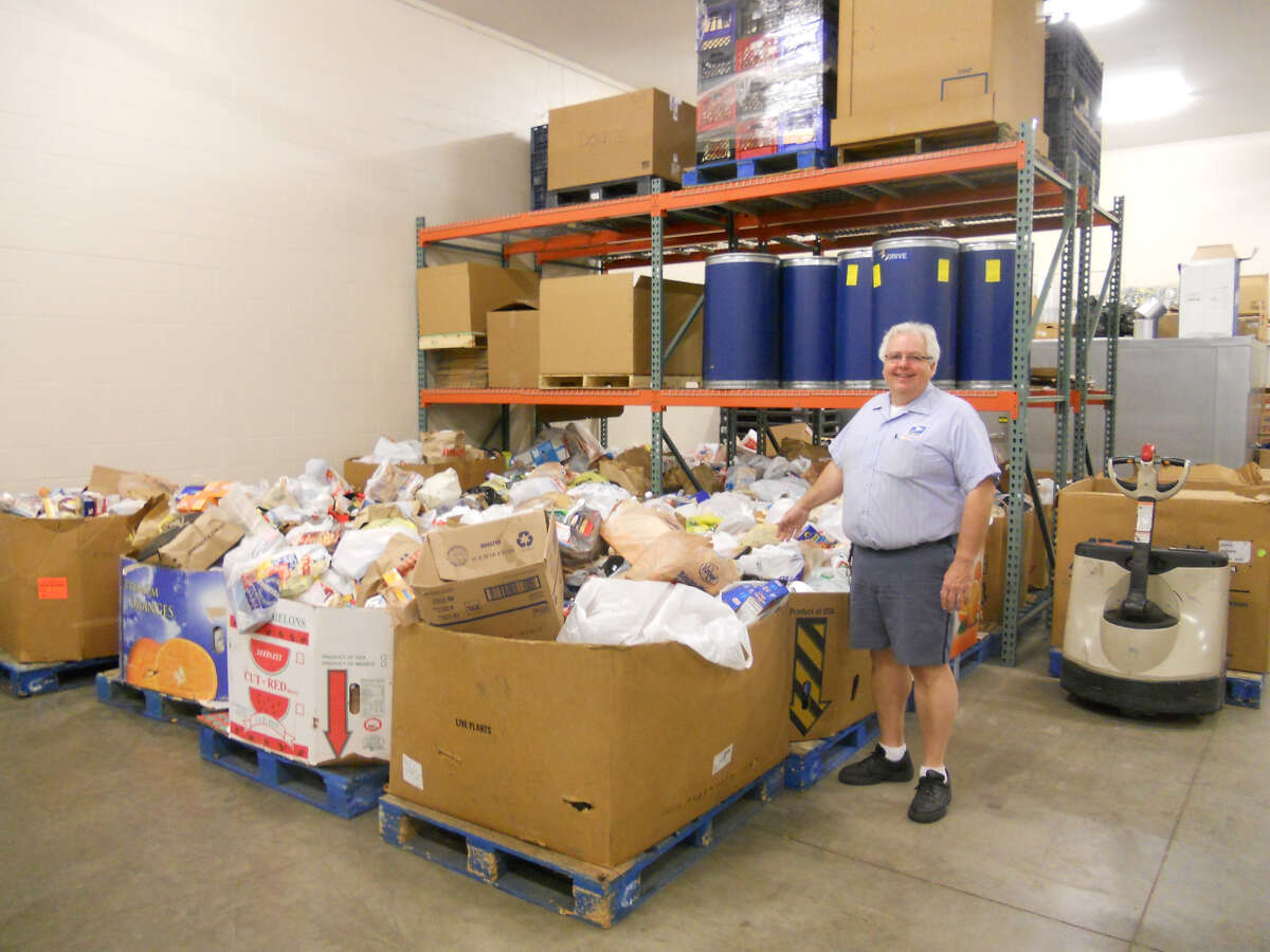 A volunteer with Hidden Harvest processes food donations. (Photo provided)