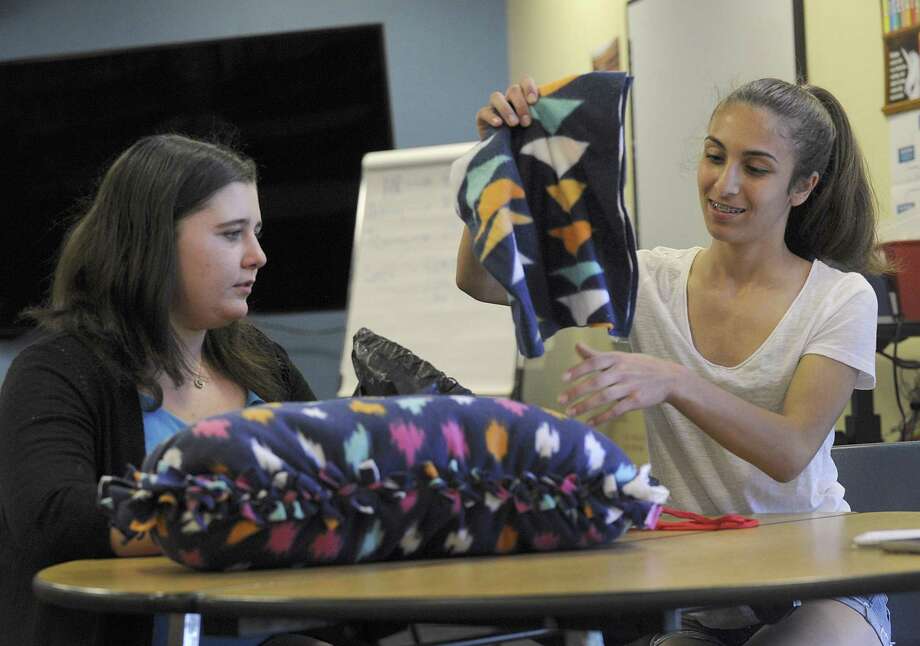 Amanda Merritt, 13, left, and Angela Carrozza, 14, display their tie pillows that they made for the homeless, Friday, May 11, 2018. A New Fairfield Middle School program called Project Citizenship, which encourages students to come up with action plans for a problem they identify in the community or the world, is coming up on its five year anniversary. Photo: Carol Kaliff / Hearst Connecticut Media / The News-Times