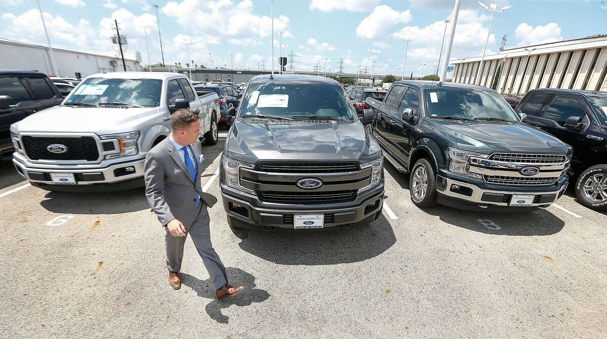 Sterling McCall's General Manager Frank Pierce walks by a row of Ford F-150 pickup trucks Friday, May 11, 2018, in Houston. Ford has barely more than two months of inventory on the best-selling F150 pickup after a fire at a magnesium plant shut down the supply chain. ( Steve Gonzales / Houston Chronicle )