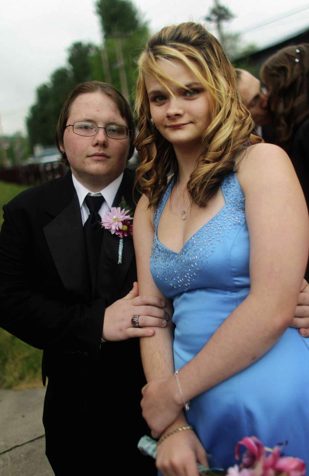 BOONEVILLE, KY - APRIL 21: Courtney Dean and Josh Sebastian pose outside the Owsley County High School prom on April 21, 2012 in Booneville, Kentucky. Daniel Boone once camped in the Appalachian mountain hamlet of Owsley County which remains mostly populated by descendants of settlers to this day. The 2010 U.S. Census listed Owsley County as having the lowest median household income in the country outside of Puerto Rico, with 41.5% of residents living below the poverty line. Familial and community bonds run deep, with a populace that shares a collective historical and cultural legacy uncommon in most parts of the country. However, the community of around 5,000 struggles with a lack of jobs due to the decline in coal, tobacco and lumber industries along with health issues including drug addiction without effective treatment. (Photo by Mario Tama/Getty Images)