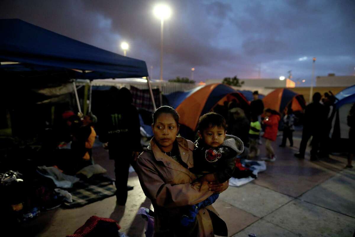 On their third day at the El Chaparral Port of Entry in Tijuana, Baja Calif, night falls on the camp where nearly 200 Central American migrants gather seeking asylum in the U.S. A reader says granting them entry may open the floodgates.