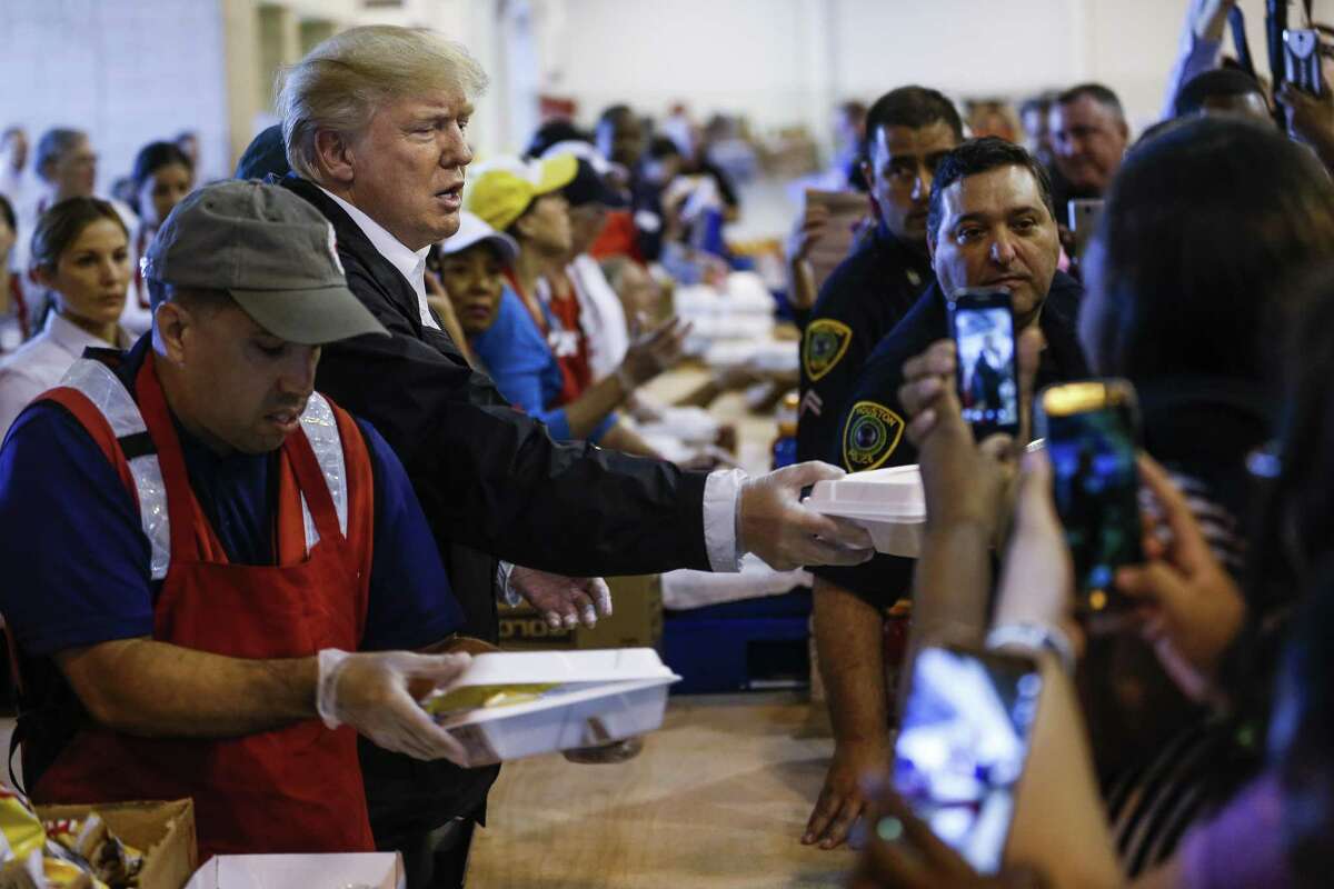 President Donald Trump serves meals to evacuees while visiting the shelter at NRG Center in Houston in the wake of Tropical Storm Harvey Saturday, Sept. 2, 2017. ( Michael Ciaglo / Houston Chronicle)