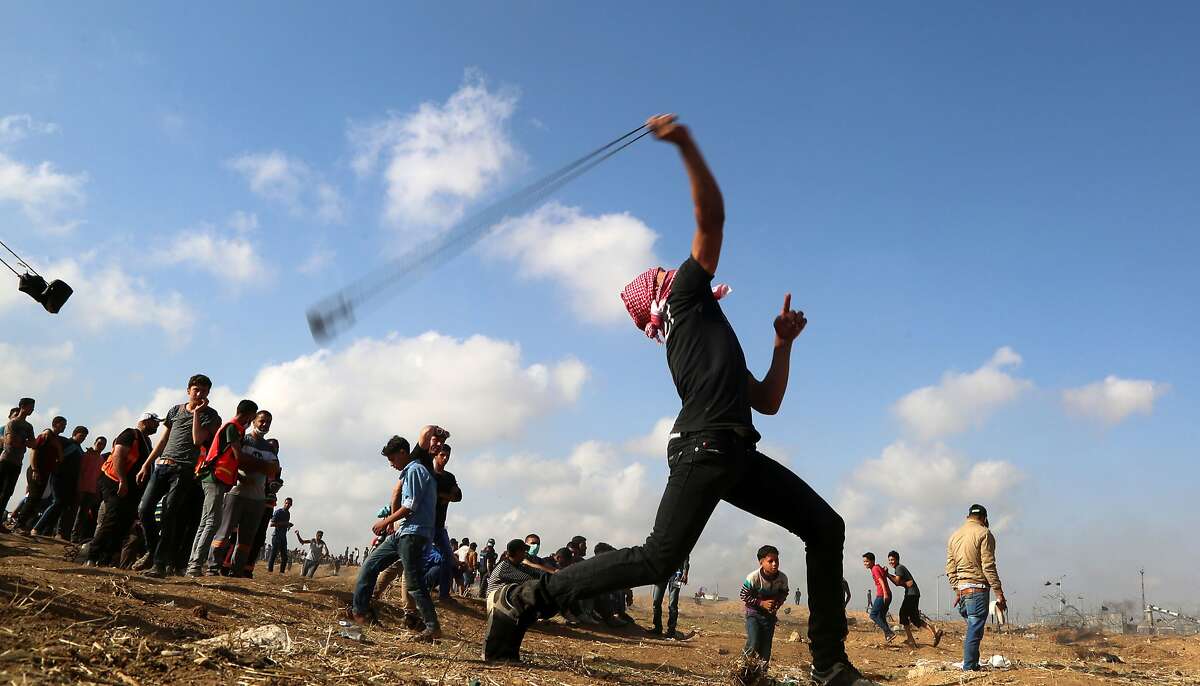 Palestinian demonstrators during clashes with Israeli forces along the border with the Gaza strip, east of Gaza City, on May 11, 2018, as Palestinians demonstrate for the right to return to their historic homelands in what is now Israel. Fifty-two Palestinians have been killed by Israeli fire since protests and clashes began on March 30 calling for Palestinian refugees to be able to return to their former homes in what is now Israel. (Majdi Fathi/NurPhoto/Sipa USA/TNS)
