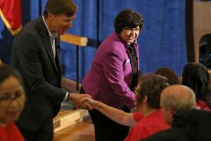 Texas Democratic Gubernatorial candidates Andrew White (left) and Lupe Valdez shake hands with audience members  after their debate Friday May 11, 2018 at St. James Episcopal Church in Austin.