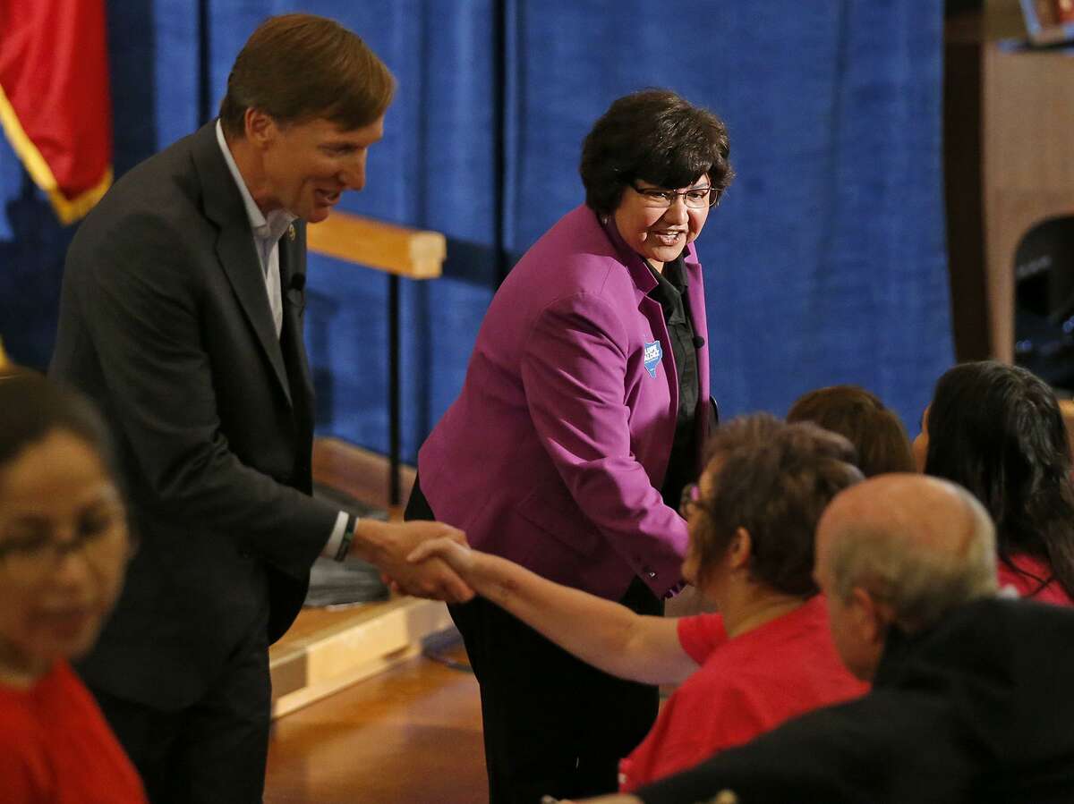 Texas Democratic Gubernatorial candidates Andrew White (left) and Lupe Valdez shake hands with audience members after their debate Friday May 11, 2018 at St. James Episcopal Church in Austin.