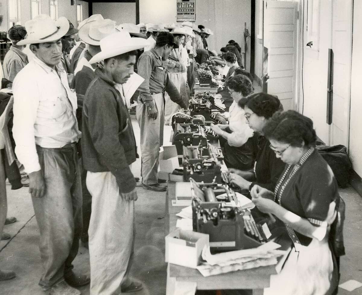This undated photo provided by the United States Citizenship and Immigration Services' (USCIS) History Library and the National Trust for Historic Preservation, shows temporary clerks completing the short-term labor contracts and identification cards. Each clerk was proficient in both Spanish and English. The bracero program is the largest guest-worker program in our nation's history and recruited 4.6 million skilled Mexican nationals. (United States Citizenship and Immigration Services' (USCIS) History Library/National Trust for Historic Preservation via AP)