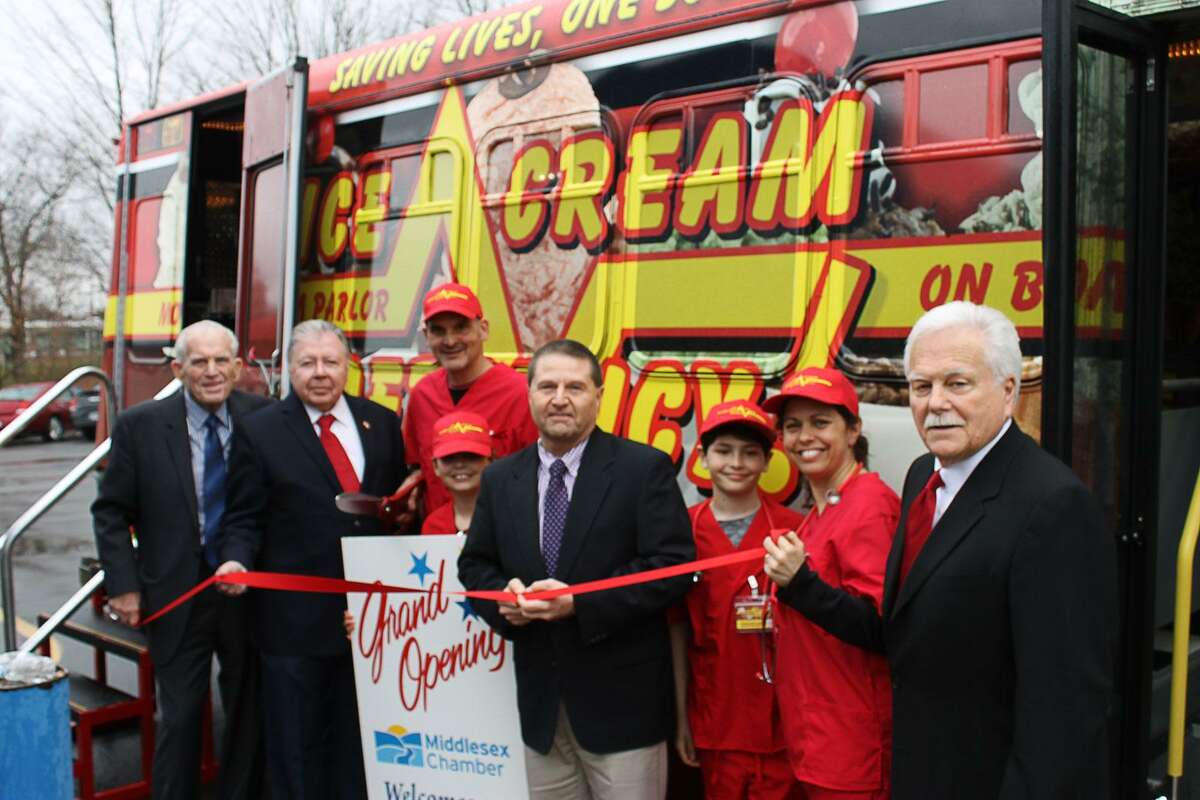 Ice Cream Emergency Central CT Territory held a Grand Opening on April 19 in Middletown. Ice Cream Emergency is a uniquely themed, full-service mobile ice cream parlor available for rentals. From left to right is Chamber President Larry McHugh, Vice Chairman Jay Polke, scoopologists Mike Natanzon and Maura Natanzon and their family, Chamber Chairman Rick Morin and Middletown Small Business Development Counselor Paul Dodge.
