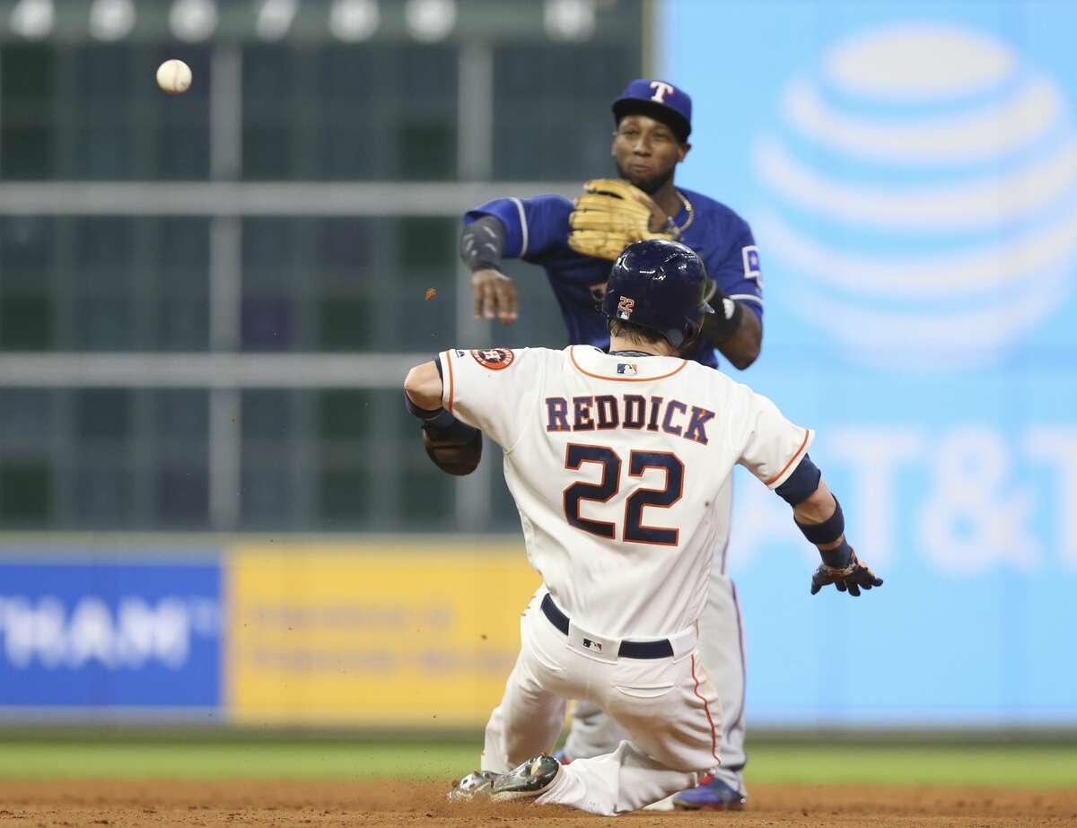 Texas Rangers shortstop Jurickson Profar (19) performs a double play as Houston Astros right fielder Josh Reddick (22) is trying to slide onto the second base during the bottom seventh inning of the MLB game at Minute Maid Park on Saturday, May 12, 2018, in Houston. ( Yi-Chin Lee / Houston Chronicle )