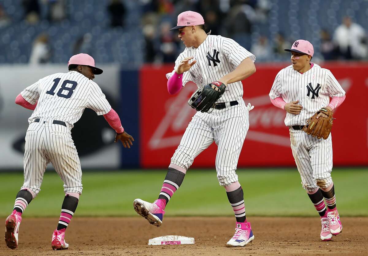 New York Yankees shortstop Didi Gregorius, Yankees right fielder Aaron Judge and Yankees second baseman Ronald Torreyes celebrate the Yankees 6-2 victory over the Oakland Athletics in a baseball game in New York, Sunday, May 13, 2018. (AP Photo/Kathy Willens)