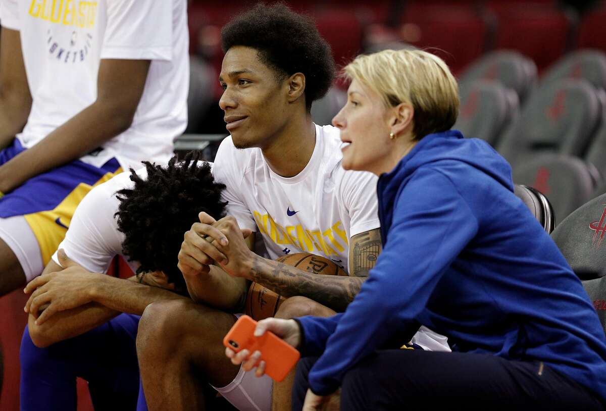 Quinn Cook, left, puts his head on Patrick McCaw as he talks wtih Chelsea Lane, head performance therapist, right, as the Golden State Warriors practiced on Sunday ahead of the Monday's Western Conference Finals game against Houston Rockets at Toyota Center in Houston, Tex., on Sunday, May 13, 2018.