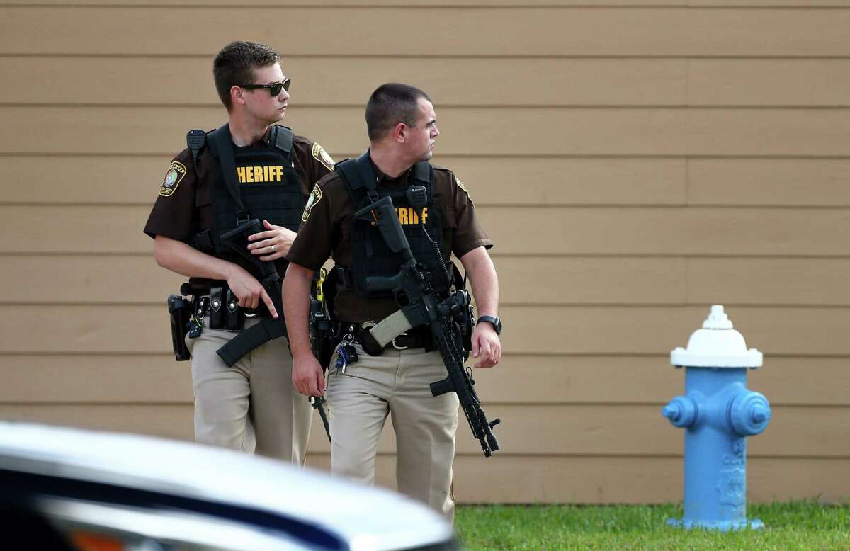 Fort Bend County Sheriff’s Office deputies investigate the scene where a man is barricaded at Willow Lake Apartments, after allegedly killing his wife Monday, May 14, 2018, in Katy, Texas. FBCSO received a call reporting that a man had killed his wife and would kill himself.