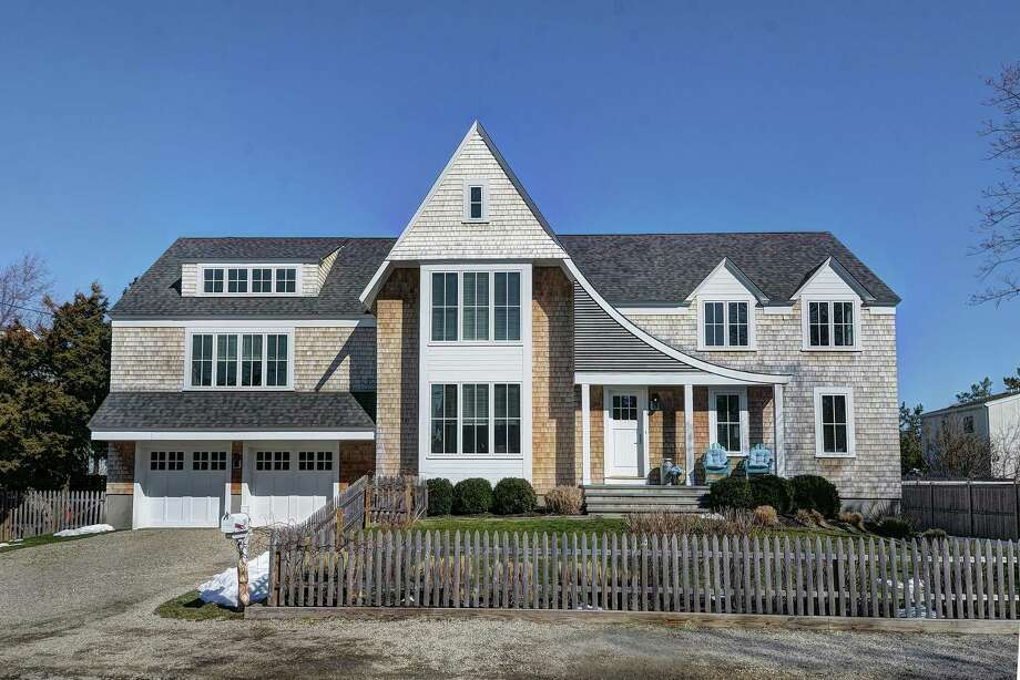 The colonial house at 15 Island Way is on Saugatuck Island, walking distance to beaches and yacht clubs.