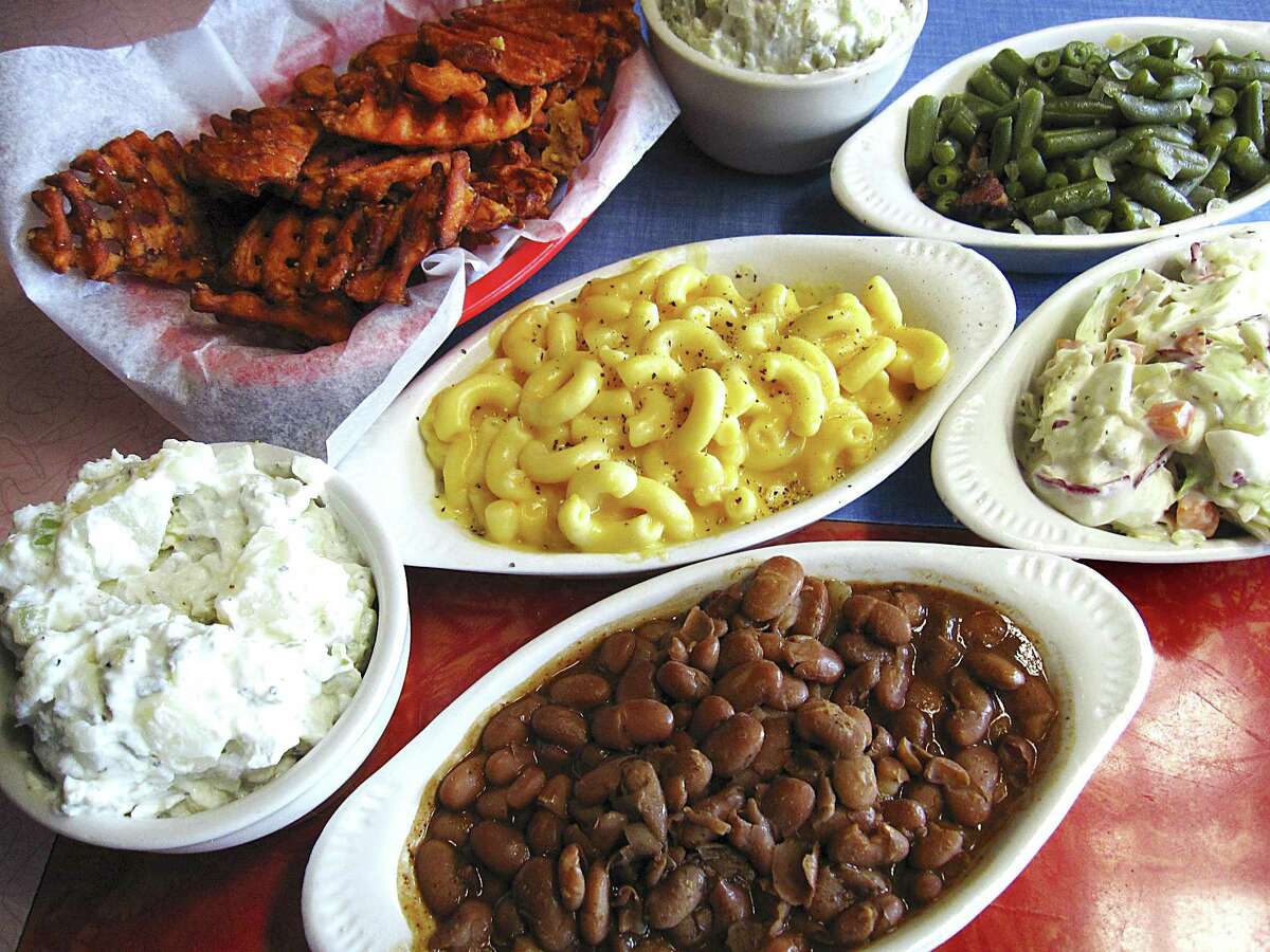 Sides from the County Line, clockwise from top left: sweet potato waffle fries, garlic mashed potatoes, green beans, cole slaw, beans, potato salad and mac and cheese.