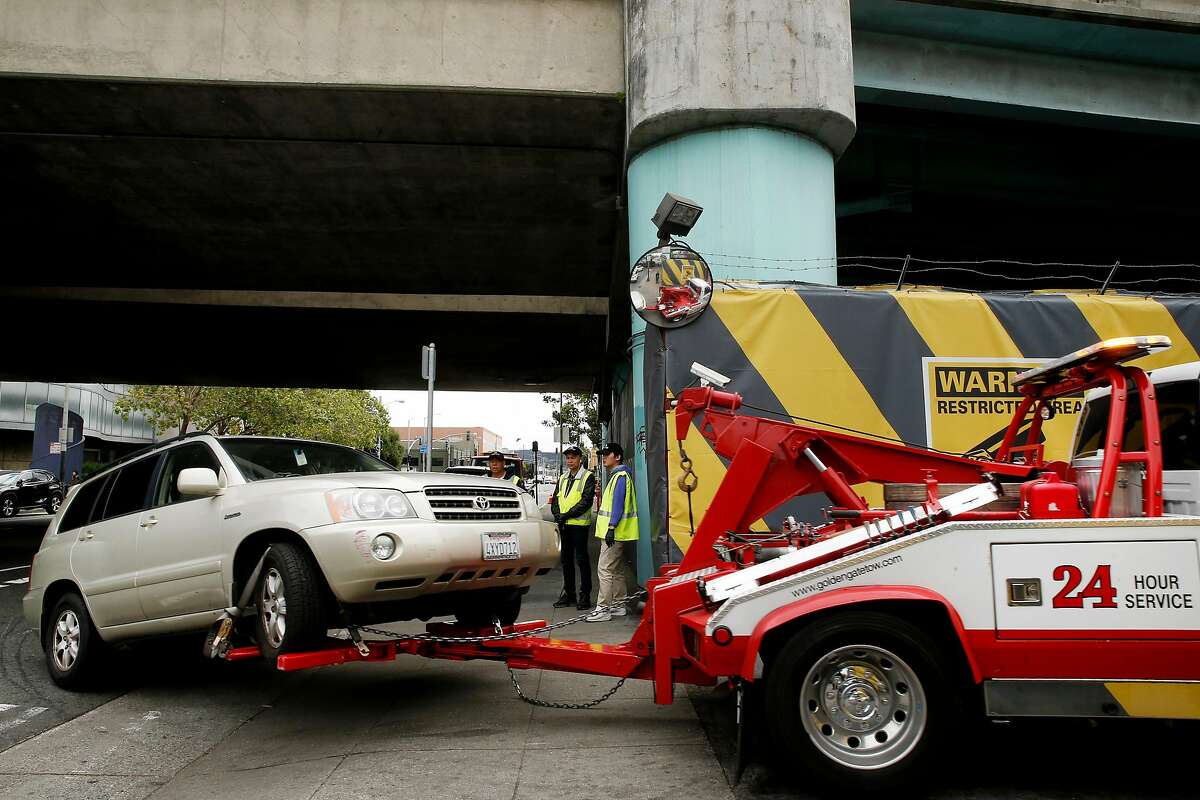 A tow truck impounds a car to the AutoReturn impound facility, Tuesday, May 15, 2018, in San Francisco, Calif.