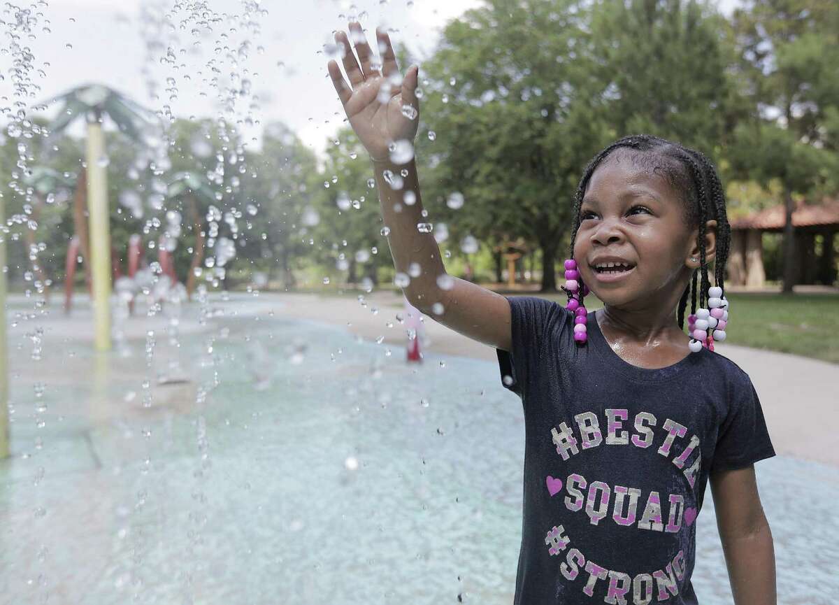 Kadynse Daniel, 4, of Houston plays in a splash pad at Hermann Park in Houston on Tuesday, May 15, 2018 as temperatures almost hit record highs. (Elizabeth Conley/Houston Chronicle)