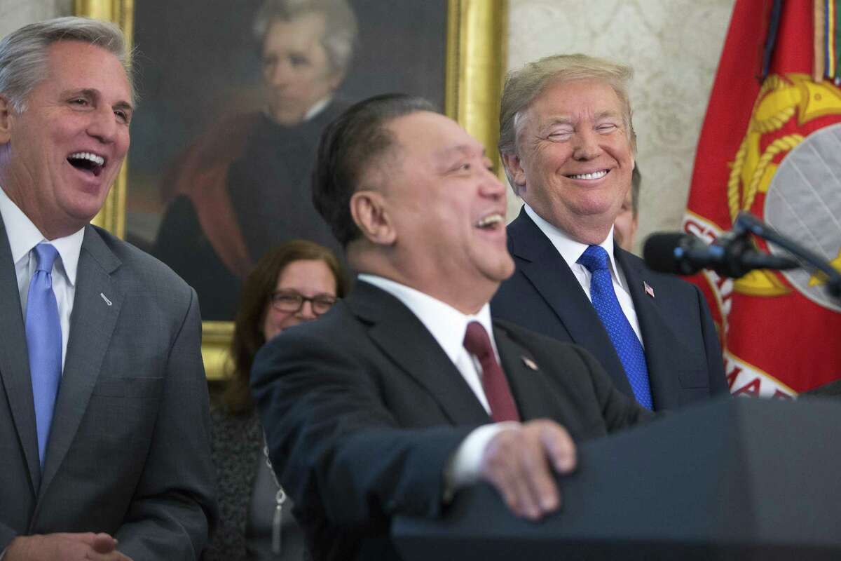 On the same day that Republican lawmakers unveiled their plan for a sweeping rewrite of the tax code, President Donald Trump and House Majority Leader Kevin McCarthy, left, laugh along with Hock Tan, chief executive of Singapore-based Broadcom, during a news conference to announce his company is moving its global headquarters to the U.S., on Capitol Hill in Washington, Nov. 2, 2017. (R-Calif.). (Tom Brenner/The New York Times)