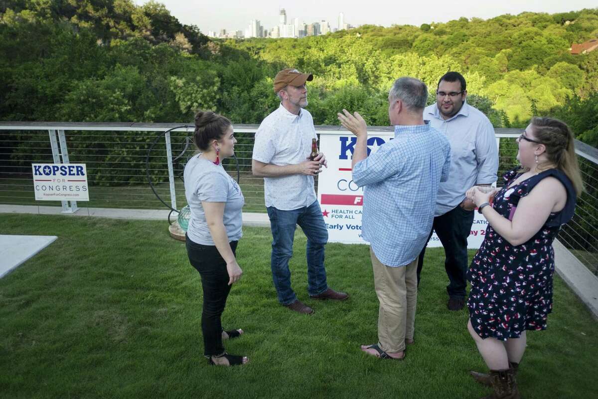Joseph Kopser, a Democrat running for the 21st Congressional District, hosted a meet and greet event in south Austin on Friday, May 11, 2018. Kopser speaks to his staff, overlooking the Austin skyline during the event. Left to right Mattea Pechter (Field Director), Joseph Kopser, Grover Bynum (Senior Advisor), Ian Rivera (Campaign Manager), Madison Kaigh (Communications Associate) photo by Kelly West