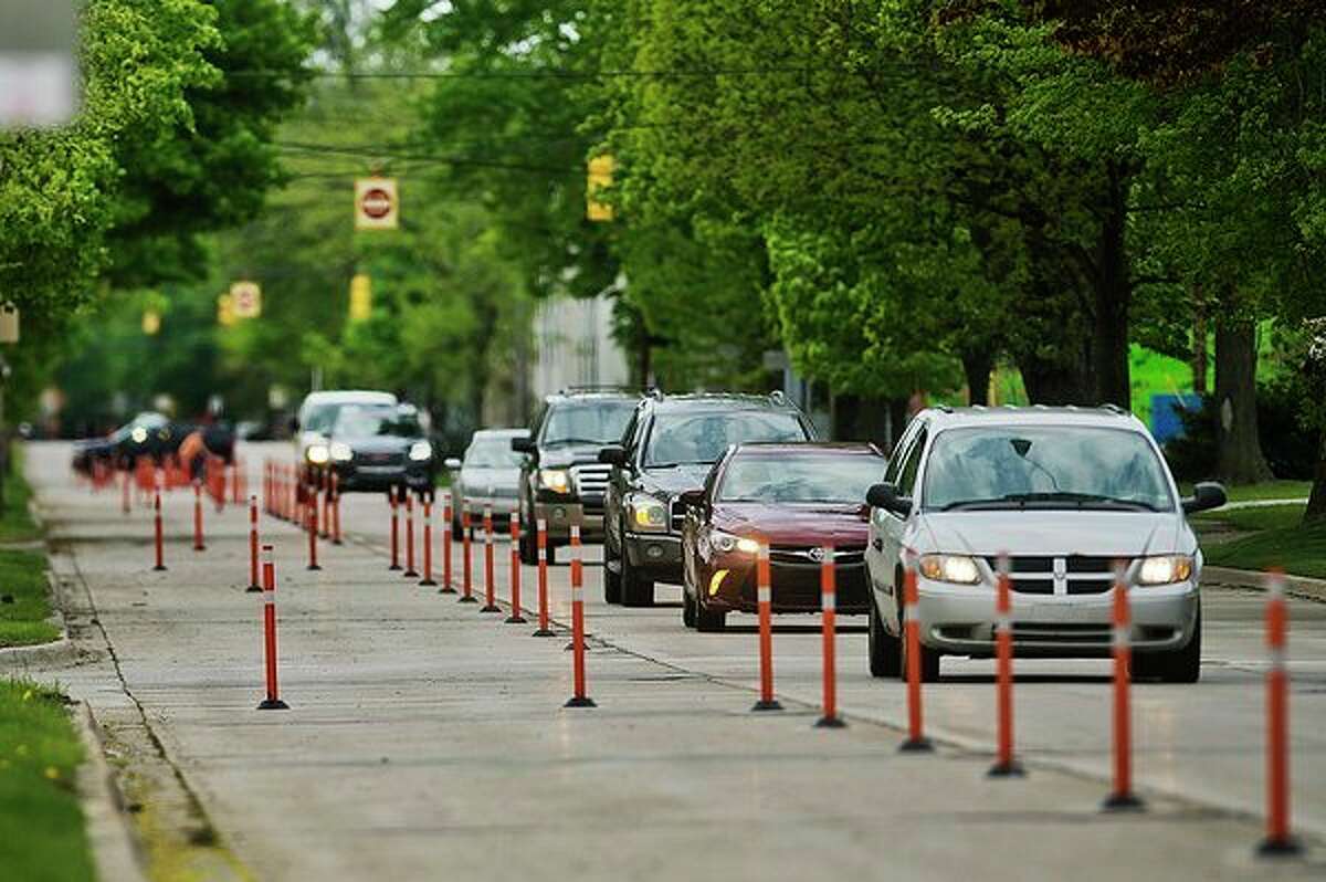 Vehicles drive down Buttles on Tuesday afternoon. (Katy Kildee/kkildee@mdn.net)