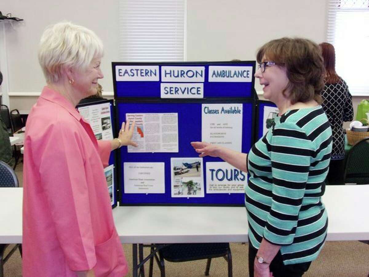 Jeanette Ginther discusses the Eastern Huron Ambulance Service with Mary Ann Godzwon at Harbor Beach Community Hospital's recent health fair. Free testing was available for area residents, and several vendors were on hand to offer advice and discuss products and services, during the health fair, which the Harbor Beach hospital holds annually. (Rich Harp/For the Tribune)