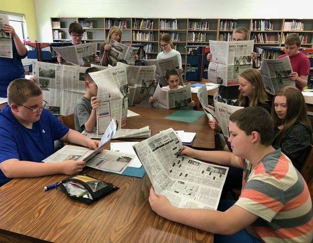 Sixth and seventh graders check out the Huron Daily Tribune, following a guest appearance from Editor Kate Hessling, who spoke with one of Doreen Paganini's classes on this week about working in journalism. (Tribune Photo)