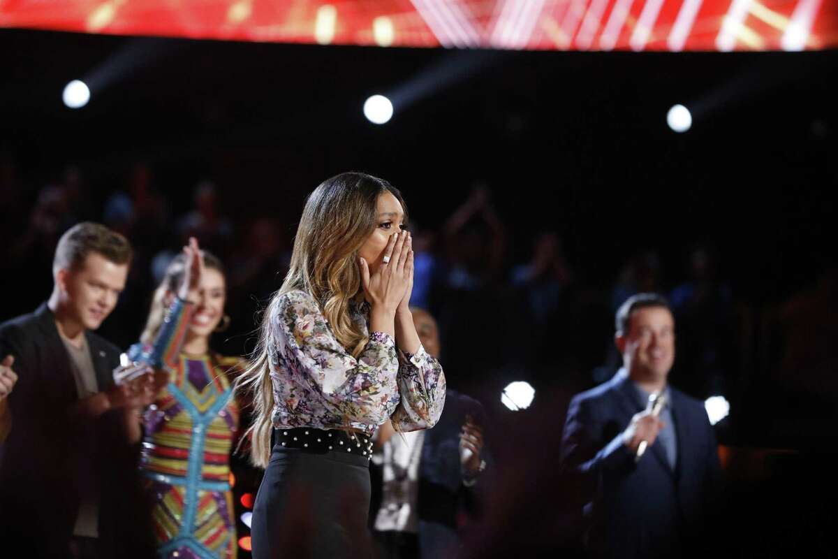 Spensha Baker of San Antonio is stunned to hear her name called out first as one of the final four on NBC’s “The Voice.” She advances to next week's finale, which will decide the winner of a record deal and $100,000.