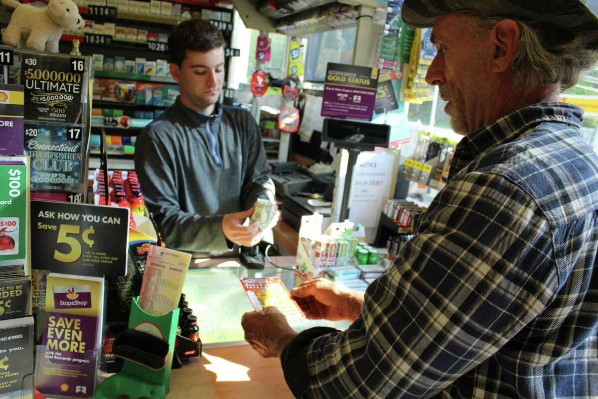John Coderre, right, buys a couple of lottery tickets from the Georgetown Shell gas station two weeks after it sold a winning $1 million Powerball ticket.