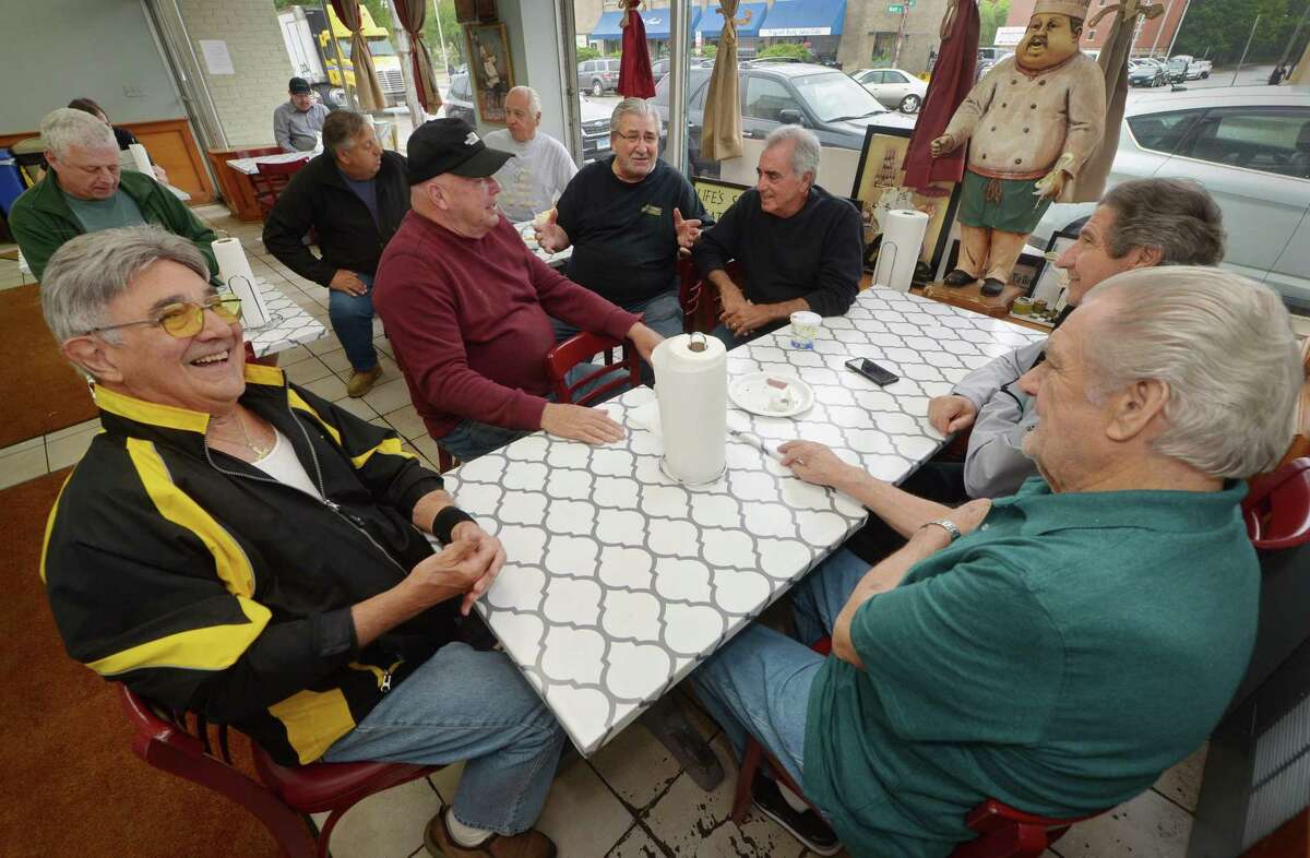 Dominck Muro, owner of Muro's New York Bakery and Deli, center, chats with his customers, Jimmy Patchen, Pete Rizzo, Tony Guaglione, Frank Marini and Stan Remson, at his establishment Wednesday, May 16, 2018, on Main Street in Norwalk, Conn. The bakery, a downtown staple in Norwalk for 66 years, will soon close its doors.