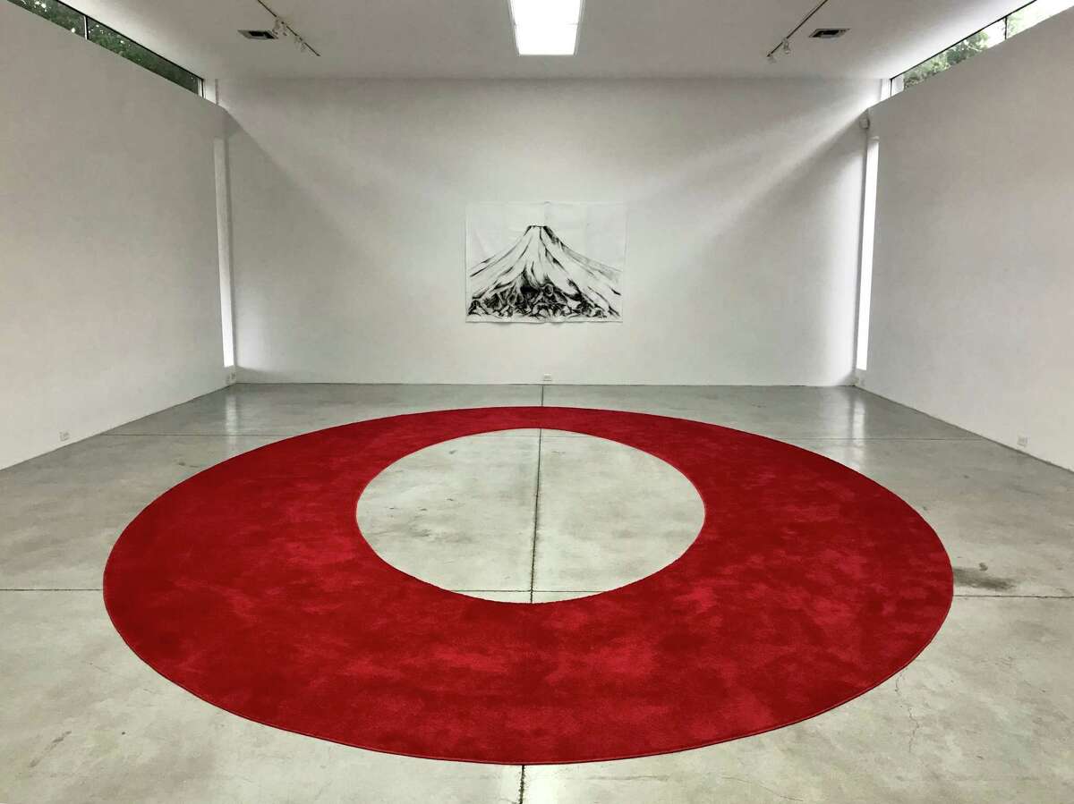 “I am a very important person,” a custom-designed red carpet, fills a floor below a charcoal drawing on felt of Mount Fuji in Ariane Roesch’s solo show “V.I.P.” at Gallery Sonja Roesch through May 26.