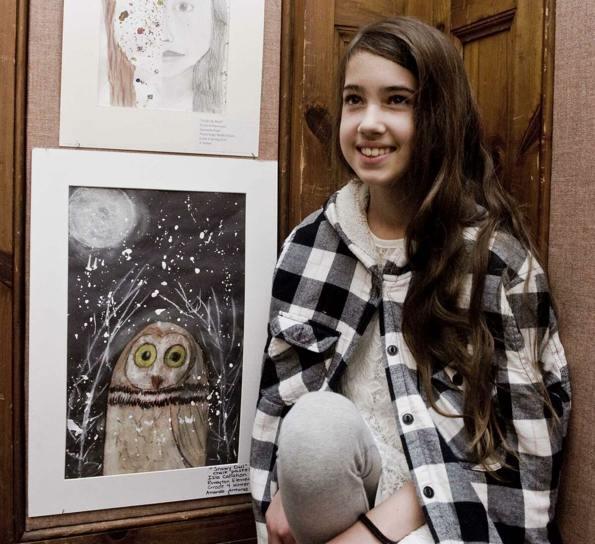 Isla Callahan, fourth-grader at Rowayton Elementary School, with her chalk pastel owl at the Norwalk Public Schools art show opening in the community room of City Hall. Tuesday, May 15, 2018