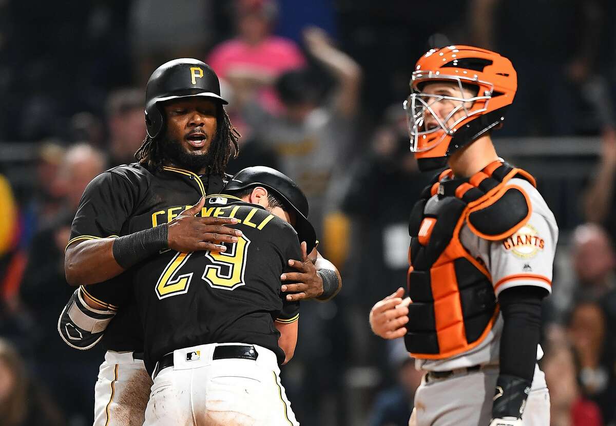 PITTSBURGH, PA - MAY 12: Francisco Cervelli #29 celebrates with Josh Bell #55 of the Pittsburgh Pirates after hitting a two run home run in front of Buster Posey #28 of the San Francisco Giants during the sixth inning at PNC Park on May 12, 2018 in Pittsburgh, Pennsylvania. (Photo by Joe Sargent/Getty Images)