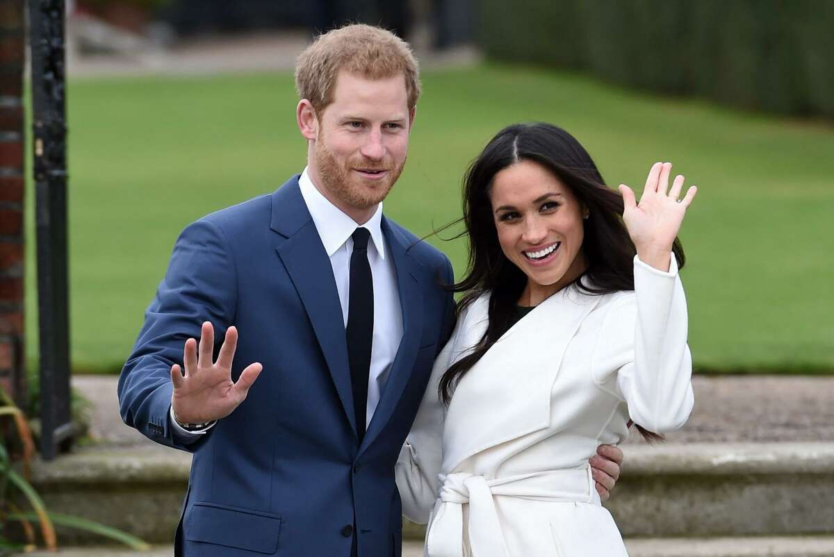 In this Nov. 27, 2017 photo, Britain's Prince Harry and Meghan Markle pose for the media in the grounds of Kensington Palace in London, after announcing their engagement. The couple will wed on May 19.