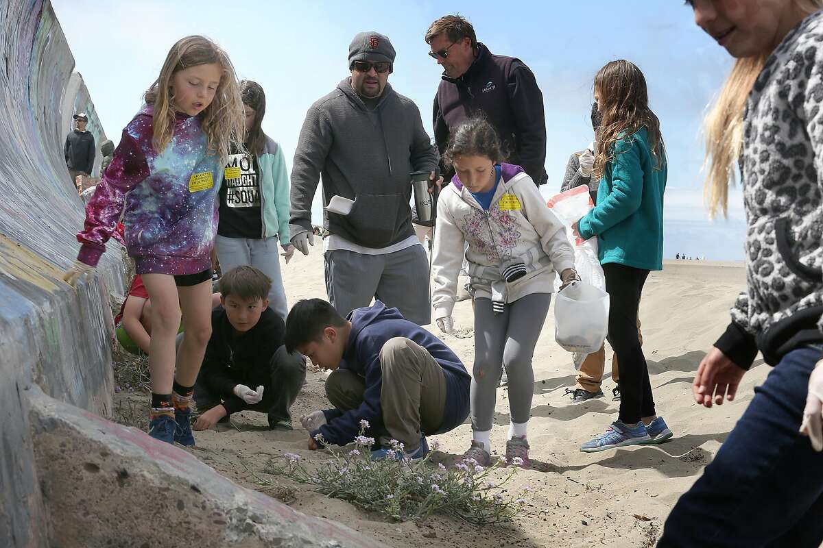Third graders from Lafayette Elementary school including Bodhi Hunt (left, tie died shirt) and Maya Guerra (middle with bucket) picked up garbage and participated at Ocean Beach for the 25th Annual Kids� Ocean Day Adopt-A-Beach Cleanup on Wednesday, May 16, 2018 in San Francisco, Calif. The Marine Science Institute is organizing the event, and is providing in-school presentations to all of the students about life in the ocean and how students can positively impact the environment.