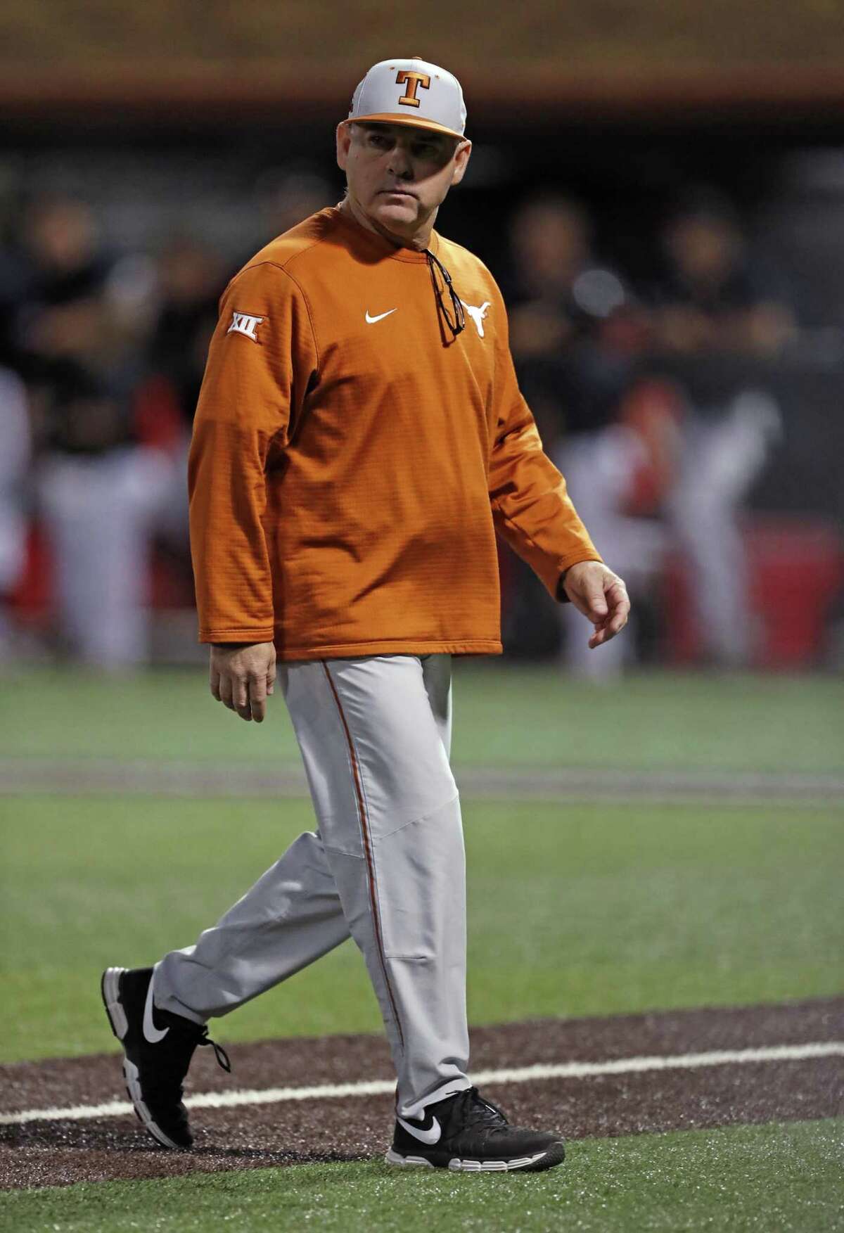 Texas coach David Pierce walks off the field during the team's game against Texas Tech on May 4 in Lubbock