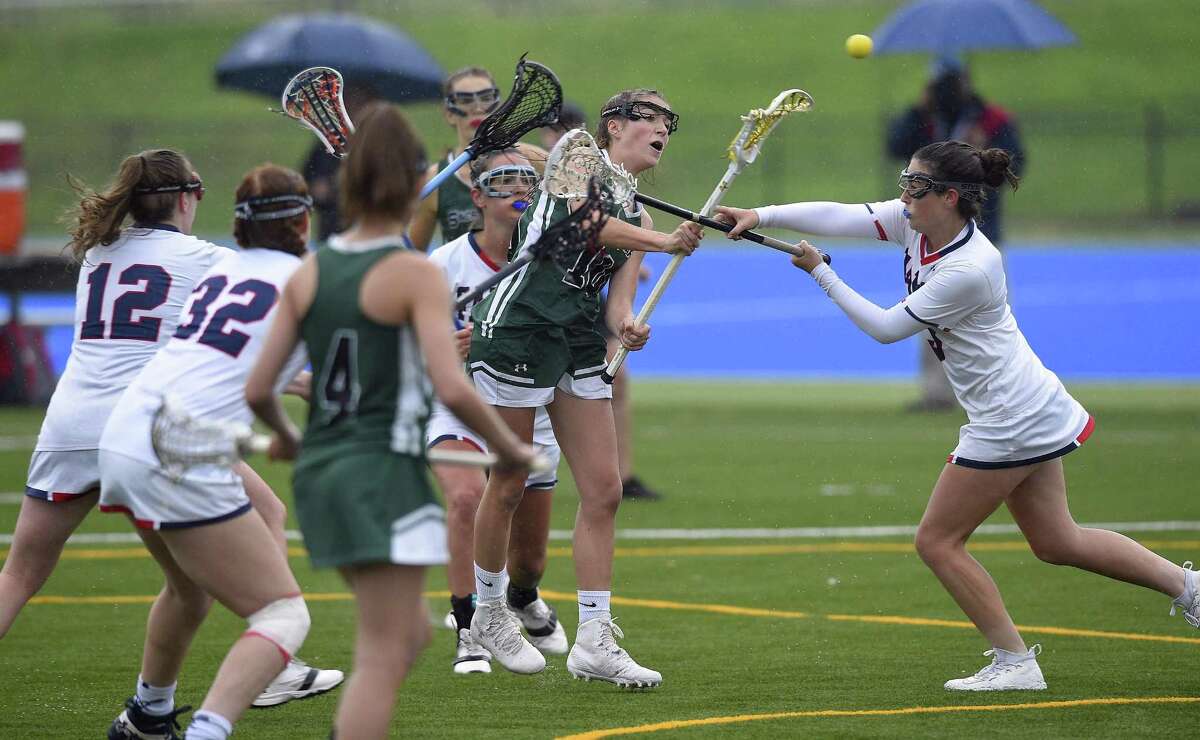 Sacred Heart's Lillian DeConcini (10) sweeps in, scoring on Green Farms Academy Sarah Peltier (3) in the first half of a FAA Tournament semifinal lacrosse game at Sacred Heart in Greenwich, Conn. on May 16, 2017. Sacred Heart won 17-1.