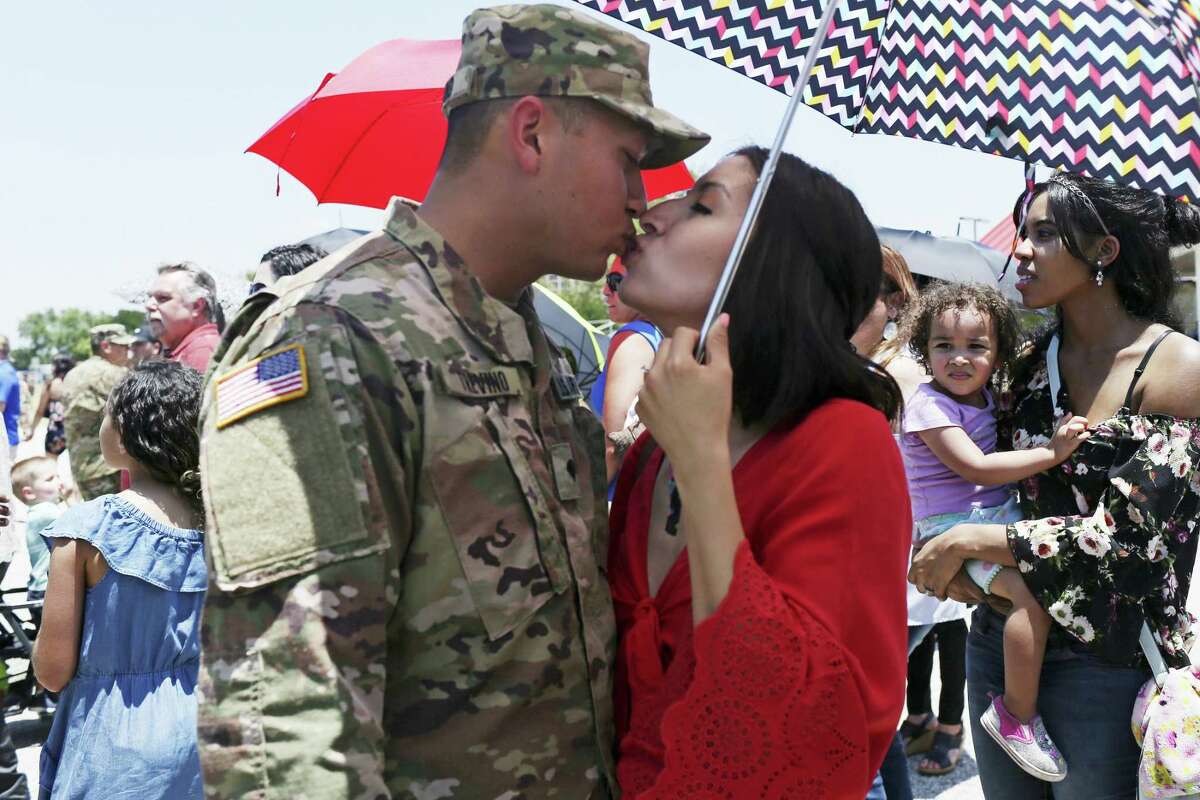 Spc. Isaac Trevino, of Del Rio, kisses his wife, Miriam, after the Texas Army National Guard 1st Battalion, 141st Infantry Regiment of the 72nd Infantry Brigade Combat deployment ceremony at Fort Sam Houston, Wednesday, May 16, 2018. The battalion, numbering close to 500, will deploy to the Horn of Africa.
