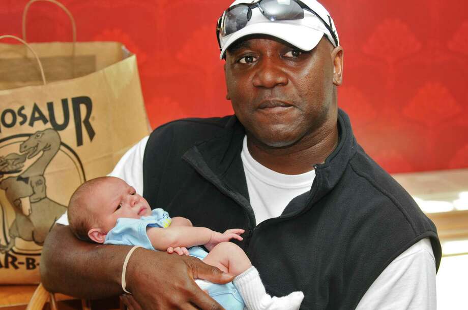 Buffalo Bills great and NFL Hall of Famer Thurman Thomas holds Phoenix, a 10 day old boy who just had intestinal surgery, during a visit to  the Ronald McDonald House on Sunday June 10, 2012 in Albany, NY.   (Philip Kamrass / Times Union) Photo: Philip Kamrass / 00018018A