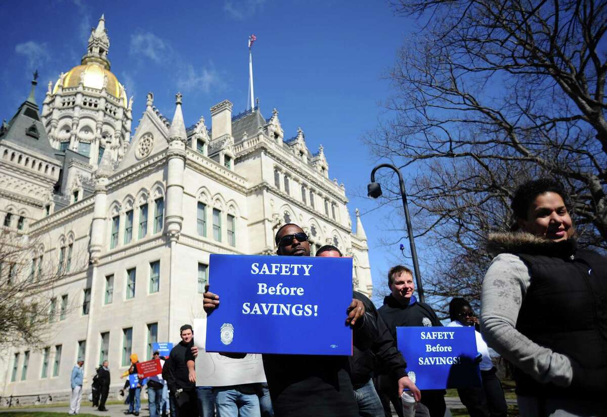 Hundreds of unionized state employees joined together to march outside of the state Capitol building to underscore how potential layoffs will affect Connecticut's quality of life in Hartford, Conn. on Tuesday, March 29, 2016.