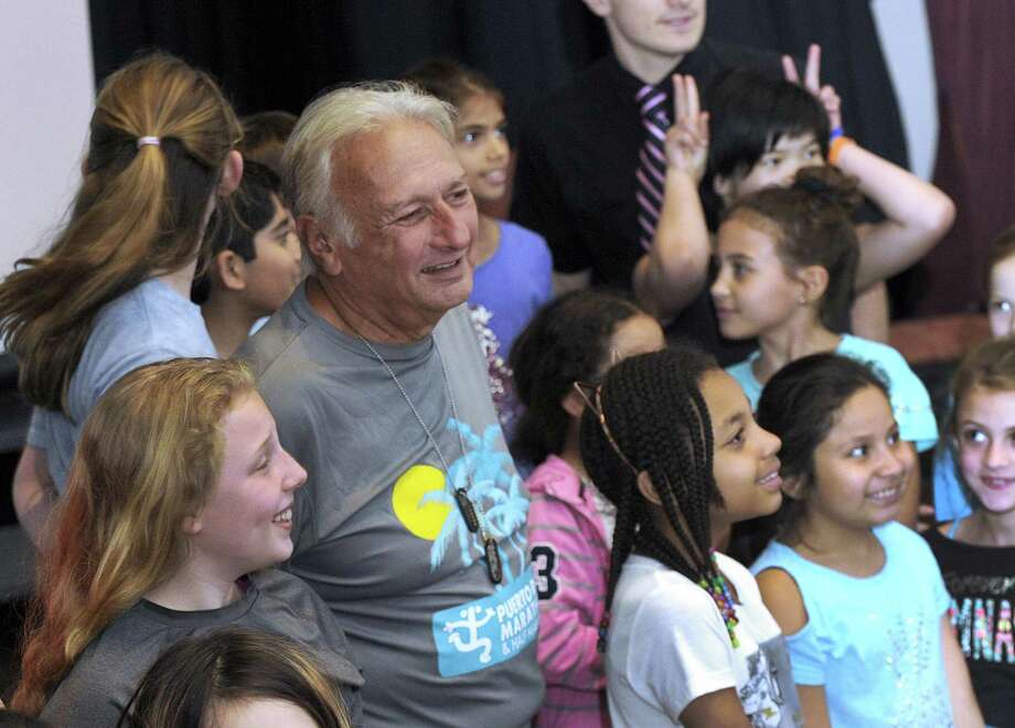 Rick Asselta, center, is surrounded by children after speaking to students at the AIS Magnet School Wednesday, May 9, 2018,  about his project to raise money for honeybee kits for Puerto Rico. Asselta has lived in Puerto Rico for several years with his wife, who is from the island. Photo: Carol Kaliff / Hearst Connecticut Media / The News-Times