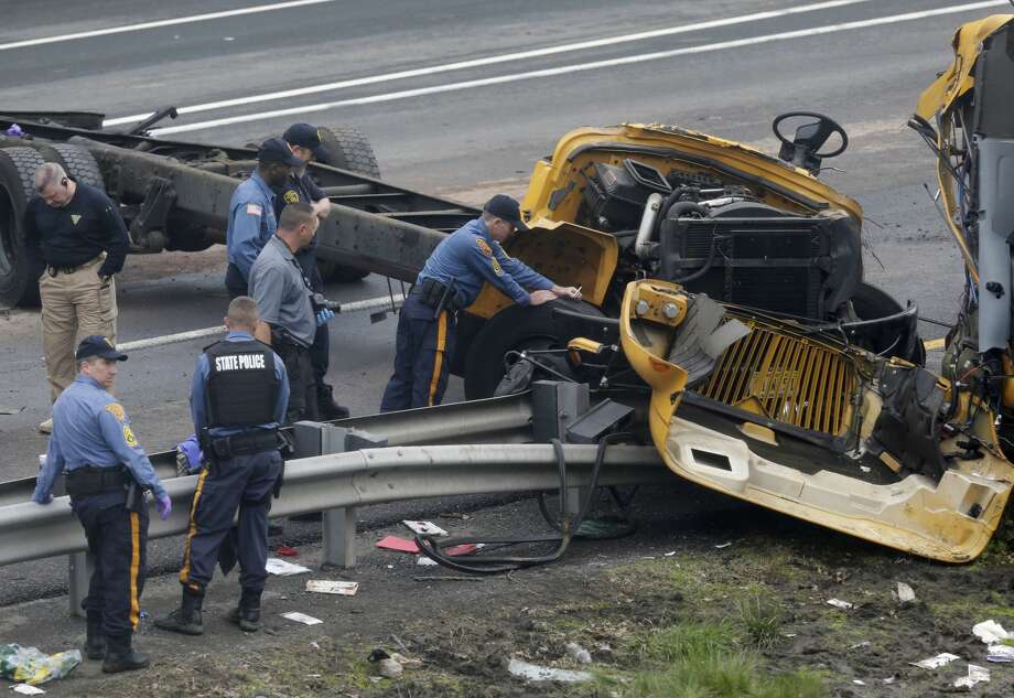 Emergency personnel examine a school bus after it collided with a dump truck, injuring multiple people, on Interstate 80 in Mount Olive, N.J., Thursday, May 17, 2018. (AP Photo/Seth Wenig) Photo: Seth Wenig/AP