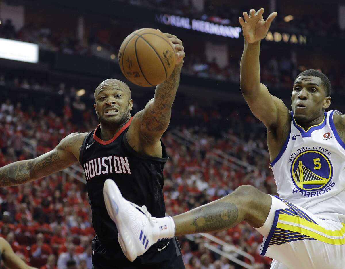 Houston Rockets forward P.J. Tucker, left, and Golden State Warriors forward Kevon Looney (5) chase a rebound during the first half in Game 2 of the NBA basketball Western Conference Finals, Wednesday, May 16, 2018, in Houston. (AP Photo/David J. Phillip)