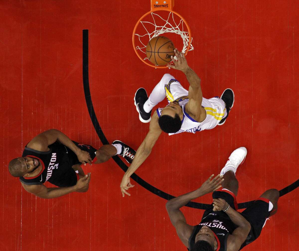 Shaun Livingston (34) dunks past Chris Paul (3) and Clint Capela (15) in the first half as the Golden State Warriors played by the Houston Rockets in Game 2 of the Western Conference Finals at Toyota Center in Houston, Texas, on Wednesday, May 16, 2018. The Rockets won 127-105.